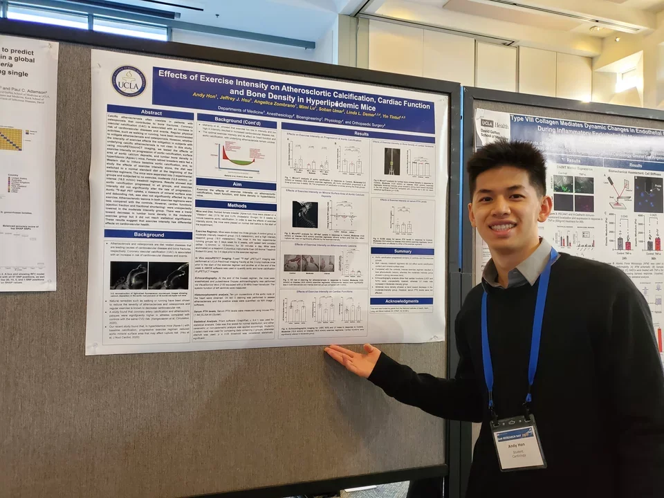 A lab member stands in front of their poster at the UCLA DOM Research Day.