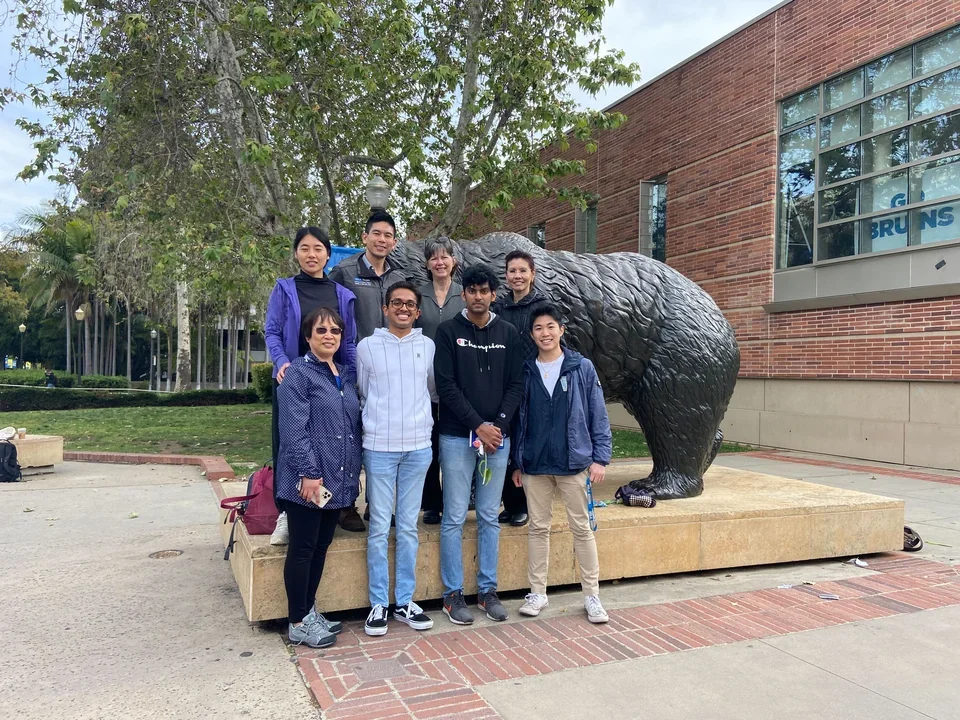 Members of Cardiovascular Calcification Research lab standing by UCLA bruin.