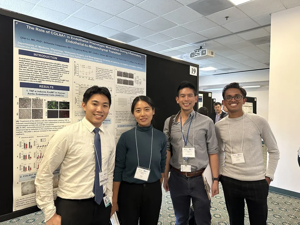 Group of four lab members stand in front of their poster at the UCLA Cardiovascular Theme Symposuim.