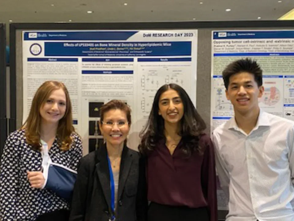 Lab members stand in front of a poster during UCLA DOM Research Day.
