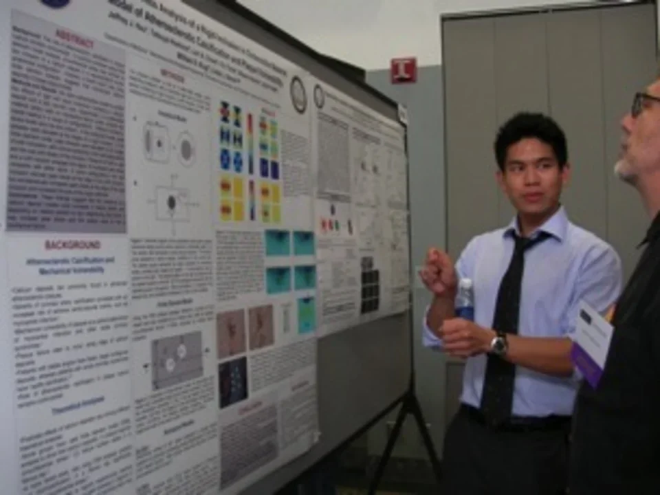 Dr. Jeffrey Hsu standing in front of a research poster.