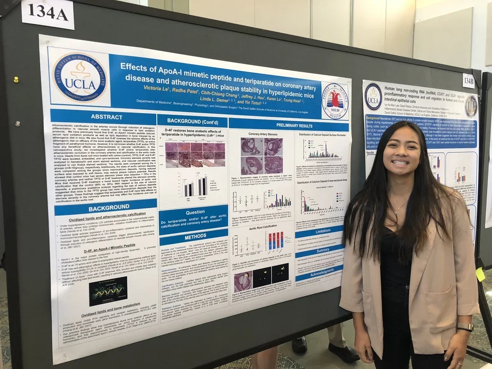 A lab member stands in front of their poster at the UCLA DOM Research Day.