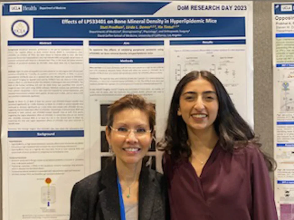 Dr. Tintut and female lab member standing in front of a poster during UCLA DOM Research Day.