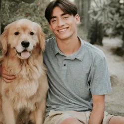 Headshot of Charlie Black with a Golden Retriever to his left.